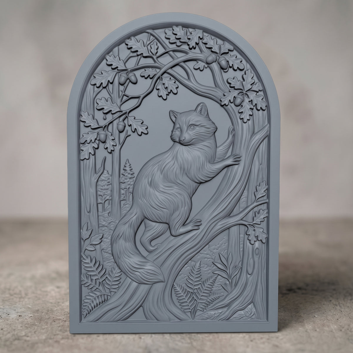 Detailed 3D bas-relief of a raccoon standing upright on its hind legs, one paw resting on a carved tree trunk, framed by an oak leaf and acorn canopy above and ferns below. Carved wood texture with fine fur detail on an arched-top rectangular panel. Designed for CNC relief carving, wood routing, and 3D printing as woodland wall decor.